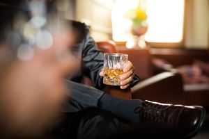 Businessman holding whiskey glass
