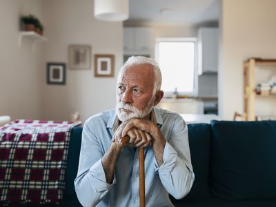 Elderly man sitting alone at home