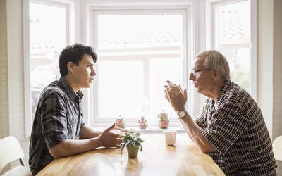 two men having a discussion at the table