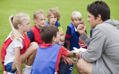 Kids surrounded by Physical education teacher