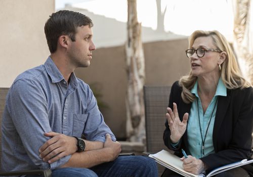 man talking with female therapist