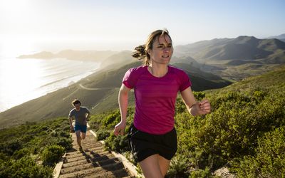 几个jogging up steps on outdoor hillside trail