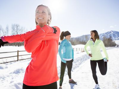 women stretching for exercise outdoors in winter