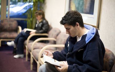 A teen waiting to see his pediatrician.