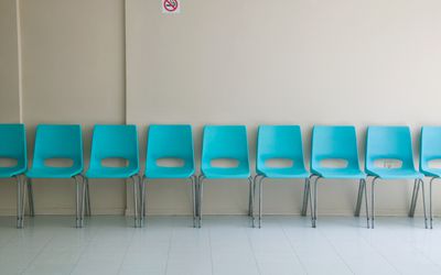 row of empty chairs in waiting room