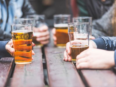 close-up of hands holding beers