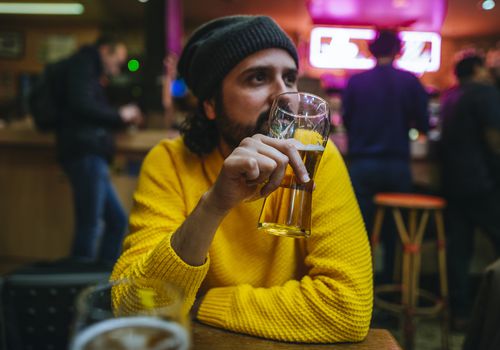 Man with glass of beer in a pub