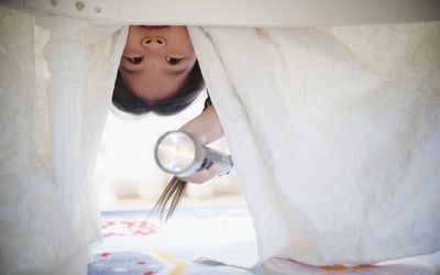 看在与手电的床下的韩国女孩