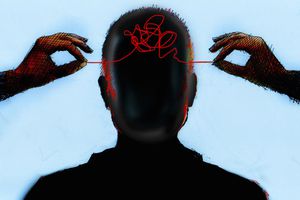 hands untangling threads in man's head