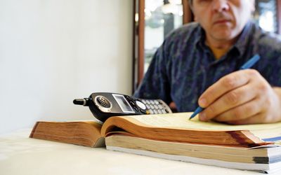 Man looking through the yellow pages.