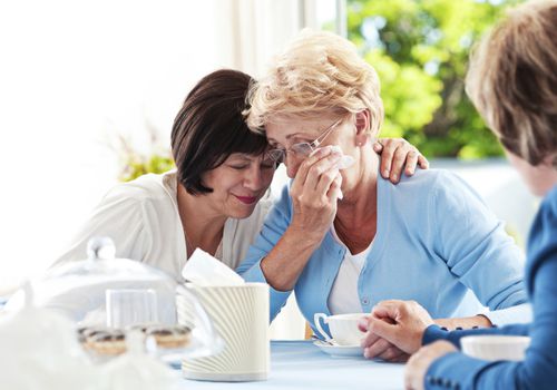 Support group members comfort family member