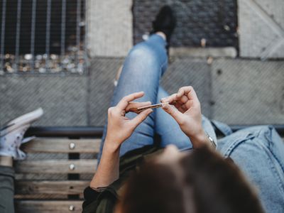 woman rolling cigarette
