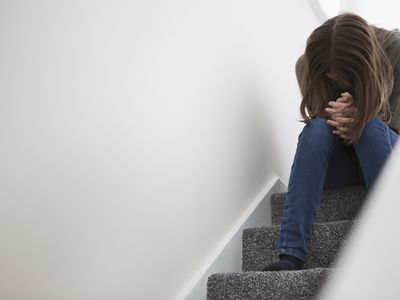 Depressed woman on staircase