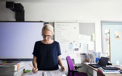 老师检查针反对空白的whiteboard在教室