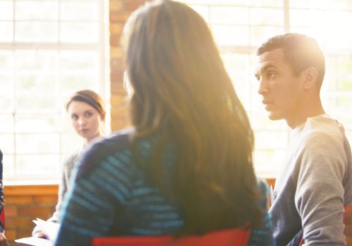 Man listening in group therapy session