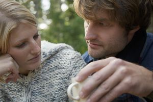 Close up of a young man looking at a young woman