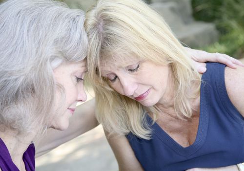 Two Female Friends Praying With One Another