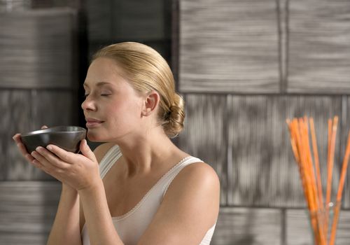 woman holding tea bowl