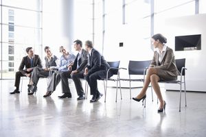 Woman sitting alone separate from group
