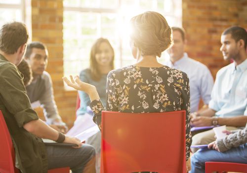 group sitting in a circle talking