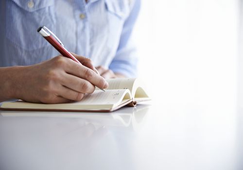 woman writing in notebook