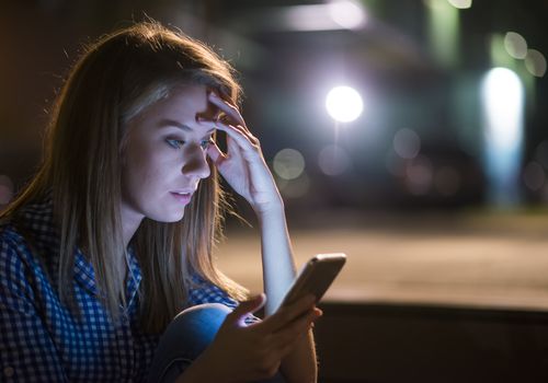 Upset woman looking at smartphone