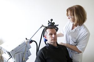 Hospital, pain centre. France. An rTMS session (repetitive transcranial magnetic stimulation) carried out by a nurse.