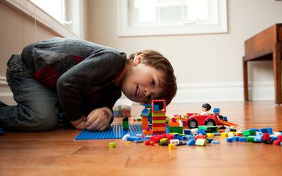 Boy looking at plastic blocks
