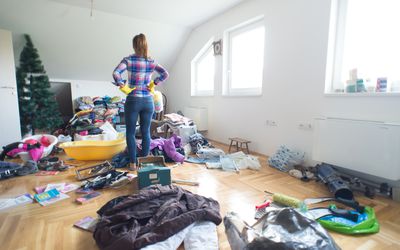 站立在房间的中心的夫人充满了杂乱