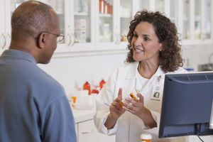 Pharmacist talking to customer about prescription