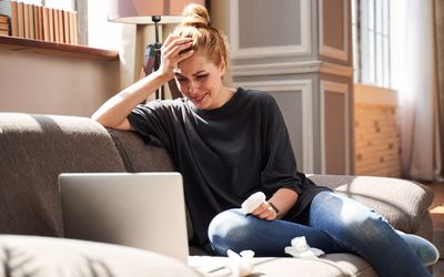 woman crying while on laptop