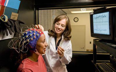 Doctor and patient with electrodes on head