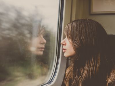 Woman looking through window in a train