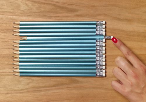 Woman organizing pencils that are all exactly the same