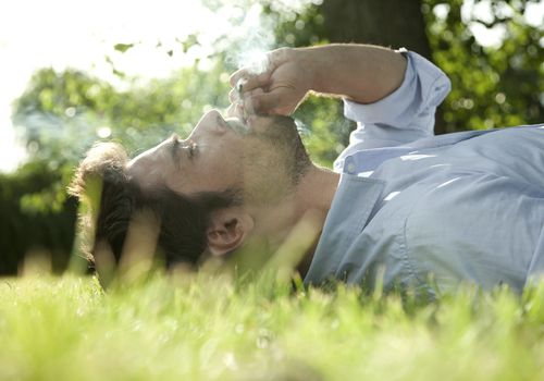 Young man smoking weed outside