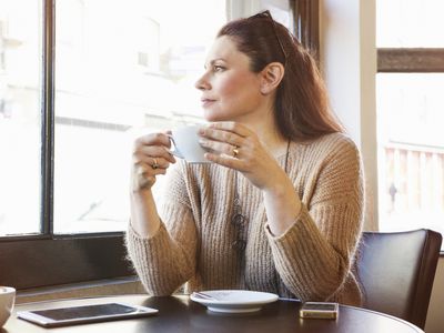 Thoughtful woman with a cup of coffee