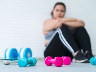 woman sitting on floor after working out