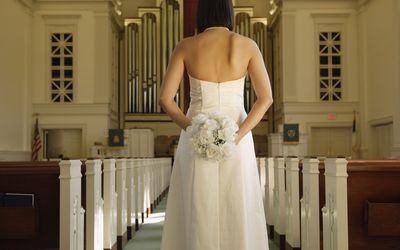 Bride standing in a church.