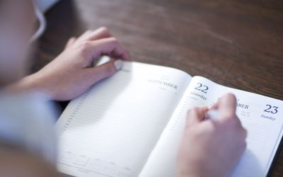 Woman writing in a day planner