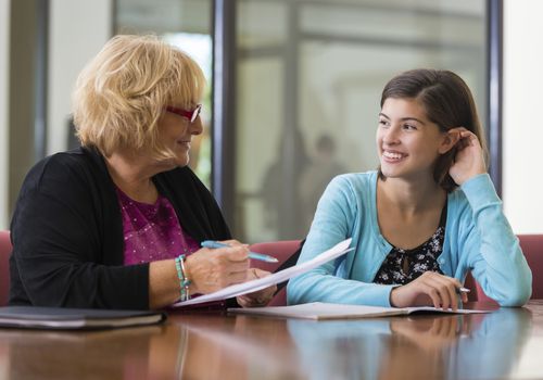 Teacher smiling at a tween girl