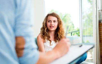 Girl talking with therapist