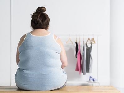Teenaged overweight girl sitting at a bench