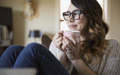 Smiling woman enjoying coffee