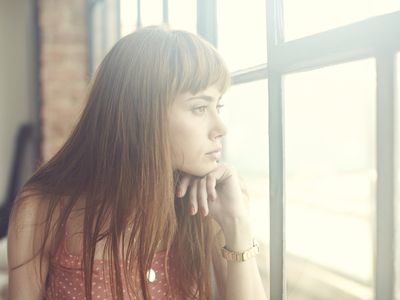 Young Woman looking out of window