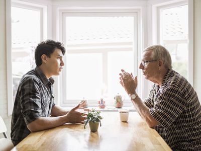 Young and old man having a discussion.