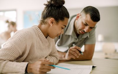 十几岁的孩子坐在教室里跟教授学习