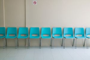 row of empty chairs in waiting room