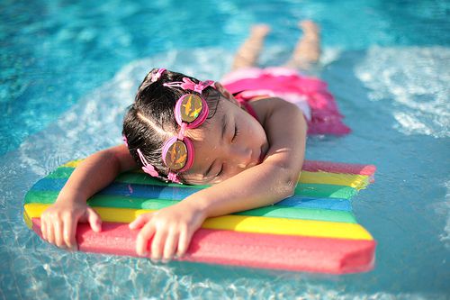 child sleeping in pool