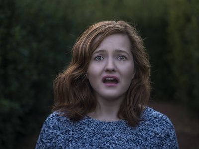 Portrait of shocked young woman looking at camera with negative facial expression