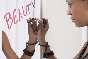 写在镜子的十几岁的女孩秀丽在唇膏“class=